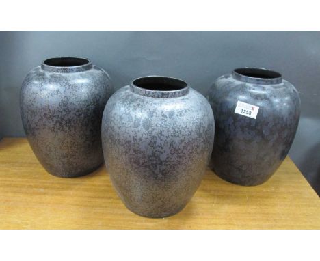 Poole Calypso Lustre Pottery Vases, with mottled decoration to black ovoid bodies, 21.5cm high. (3).
