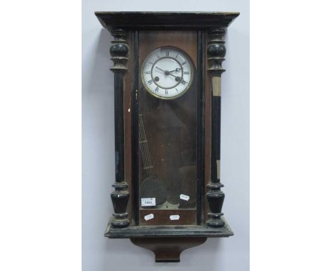 XIX Century Walnut Ebonsed Vienna Wall Clock, with a glazed door, turned columns, and enamel dial.