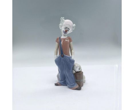 A glossy figure of a sad clown with his hands in his pockets, with his luggage and dog beside him. 1996 Event Figurine. Lladr