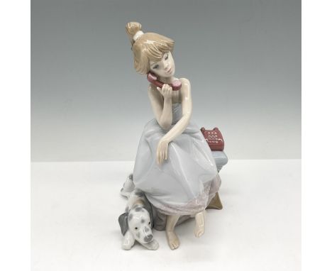 Glossy figure of a seated young woman on the phone. A spotted dog beside her. Signed and dated. Lladro backstamp. This item h