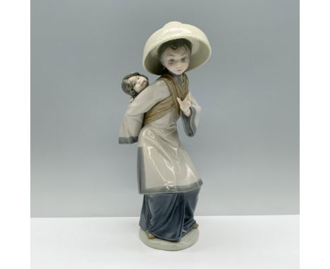 A mother in a gray robe carries her infant on her back with tender caution. Lladro backstamp This item has a box which measur