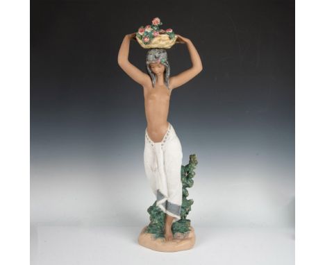 A stunning 30-inch tall figure of an odalisca topless with a light-colored skirt and long dark hair. She is shown carrying a 