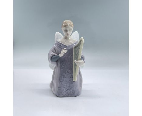 Glossy porcelain figure of a lady angel in a purple dress kneeling down playing a harp. Lladro backstamp. Includes original b