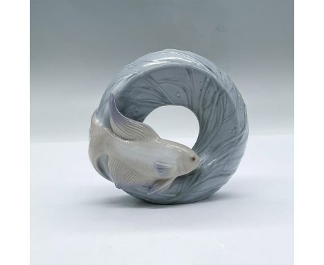 A glossy figure of a standing ring designed to look like the ocean, adorned with a fish. Lladro backstamp. This item has its 