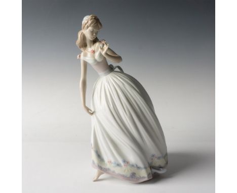 A glossy figure of a princess wearing an exquisite gown adorned with delicate floral details and her heel gracefully fallen b
