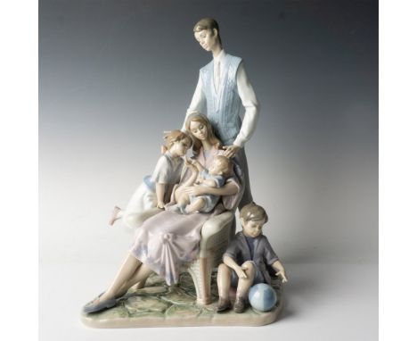 A glossy figure depicting a tender moment between a father, mother and their three children as they relax in their home. Llad