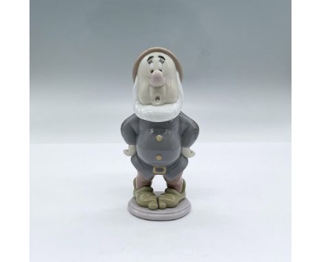 A glossy figure of one of the seven dwarfs from the Snow White fairy tale. He has a worried expression with slightly widen ey