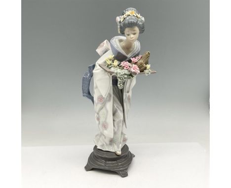 Glossy figure holding tray of flowers, dressed in traditional kimono and colored in soft pastels. Lladro backstamp. This item