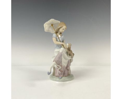 A glossy figure of a woman seated with her dog who is affectionately gazing at her. 5th Anniversary Lladro Collectors Society