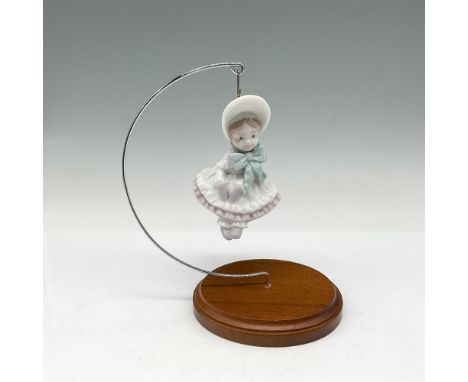 Glossy ornament dressed with bonnet, ruffled dress and mittens. Lladro backstamp. This item has its original box: 4.5"L x 4.2