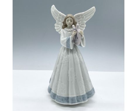 Glazed porcelain figure of a young lady angel in a white dress with blue accents playing a harp. Lladro backstamp. This item 