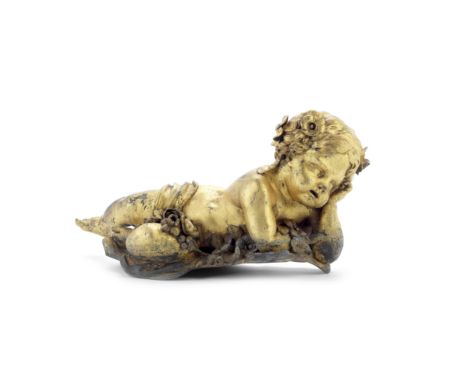 A late 19th century gilt copper alloy figural mount of a puttipossibly formerly part of an architectural mountthe recumbent i