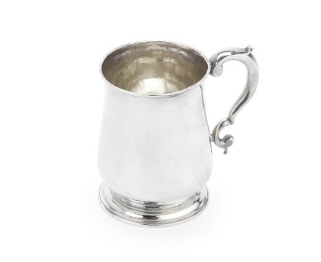A George II silver mugThomas Rush, London 1743Plain baluster form with scroll handle on a circular stepped spreading foot, he