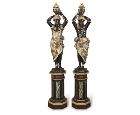 A pair of late 19th Century Venetian gilt and polychrome decorated carved wood figures of Moors raised on pedestal stands the