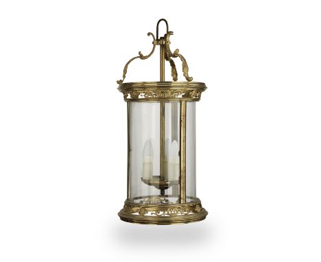 A late Victorian gilt brass hall lanternof cylindrical form fitted three sectional curved clear glass panels, the acanthus sc