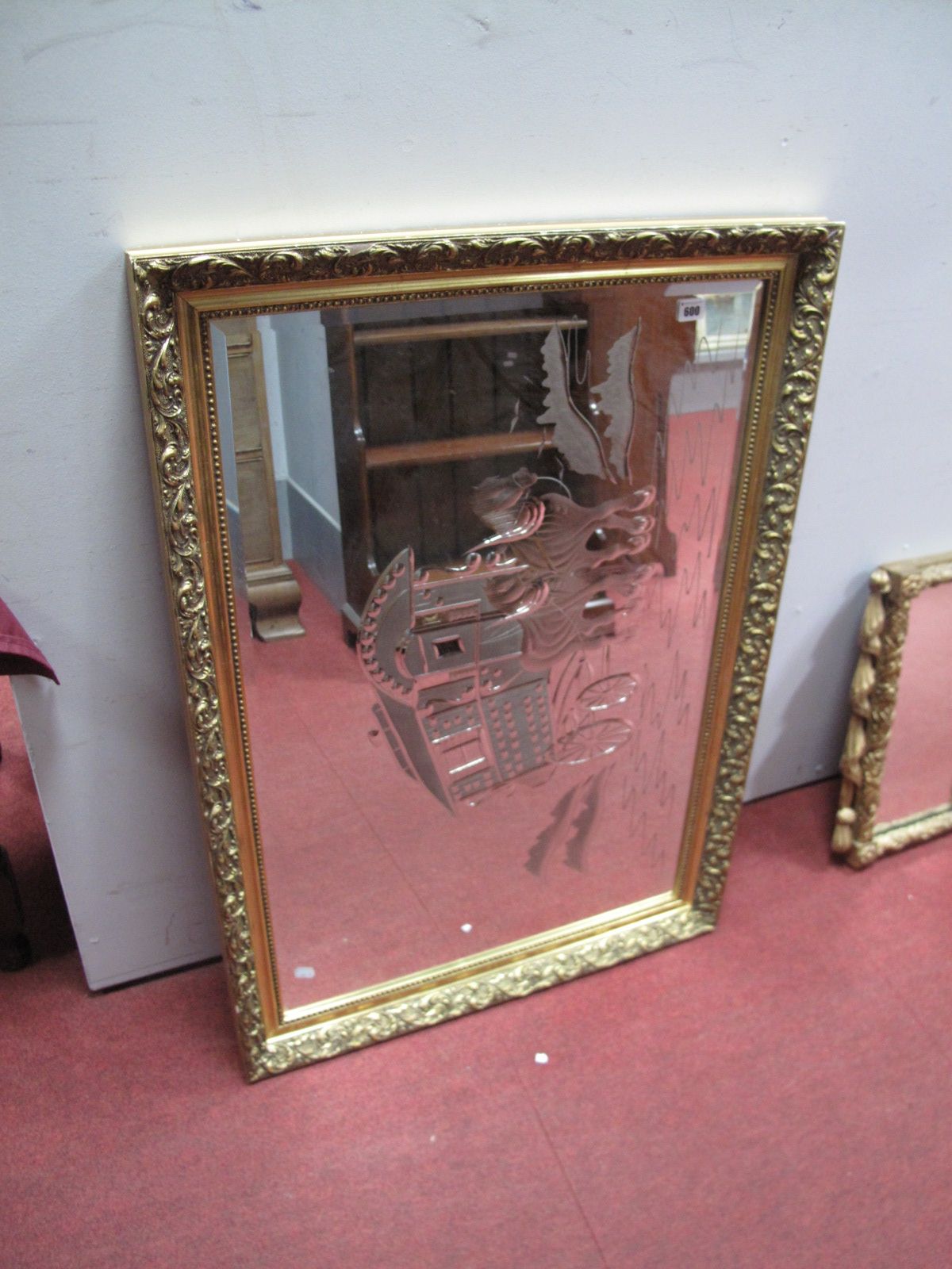 A Rectangular Bevelled Wall Mirror, with central etched depiction of a