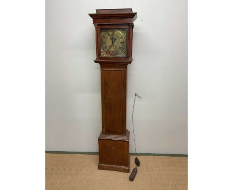 An early 19th century oak and mahogany crossbanded thirty hour longcase clock, the brass dial set with Roman numerals and twi