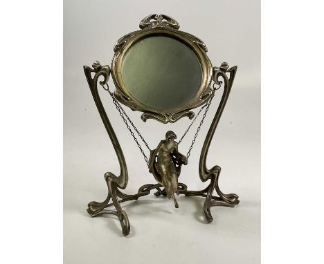An Art Nouveau style decorative swing mirror, stamped Erte, Paris 1907, modelled as a figure on a swing, height 46cm.