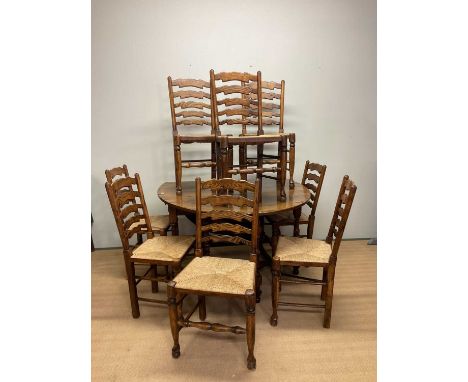 TITCHMARSH &amp; GOODWIN; a large reproduction oak gateleg drop-leaf dining table, height 74cm, width 128cm, and eight wavy l