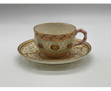 ROYAL WORCESTER; a miniature double walled reticulated cabinet cup with jewelled details and painted with a butterfly, green 