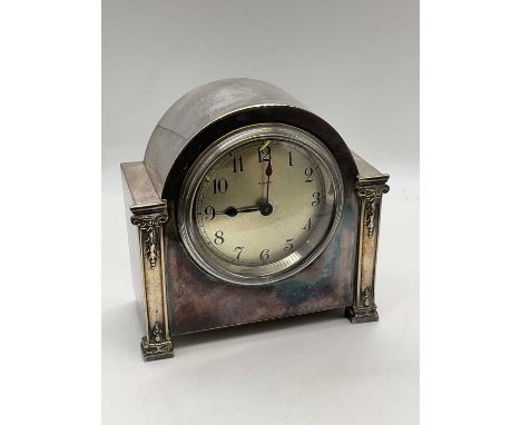 An Art Deco silver plated eight day mantel timepiece, with Arabic numerals to the circular dial, width 15.5cm.