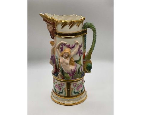 ROYAL WORCESTER; a nautical mask jug relief decorated with mermaids and shells, with stylised dolphin handle, green printed m