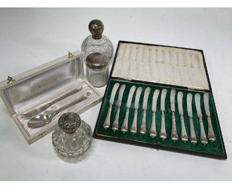 Three silver topped glass dressing table bottles with a Christofle boxed spoon and fork and a Mappin amd Webb cased set of bu