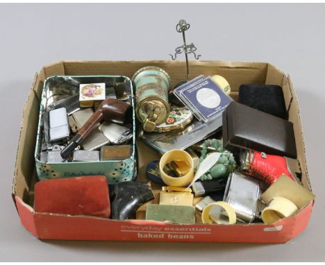 A box of collectables to include coins, lighters, napkin rings and pipe etc.
