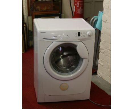 A white enamel Hoover Optima washing machine with 1400 spin speed and 8kg maximum load.