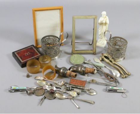 A box of collectables to include a white metal stamp box and cup holders along with napkin rings and wine stoppers, etc.