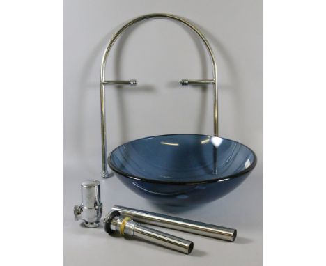 A glass bathroom basin and accessories.