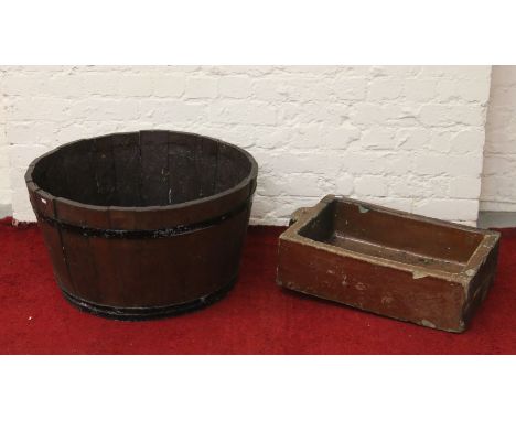 A circular wooden metal bound half barrel planter along with a treacle glazed sink planter.