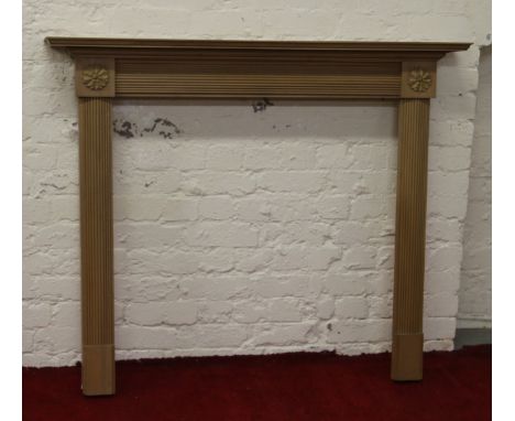 A carved pine fire surround with reeded mouldings.