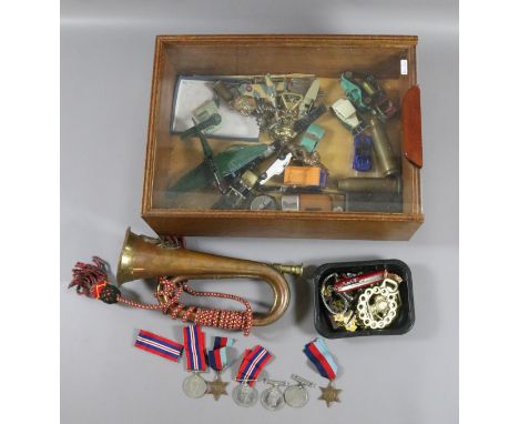 A bijouterie box containing collectables including Second World War medals, brass and copper bugle, diecast cars and planes, 