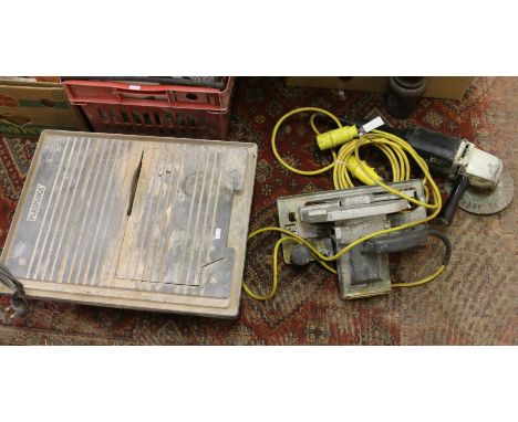 An electric tile saw, a 110 volt circular saw and a grinder.