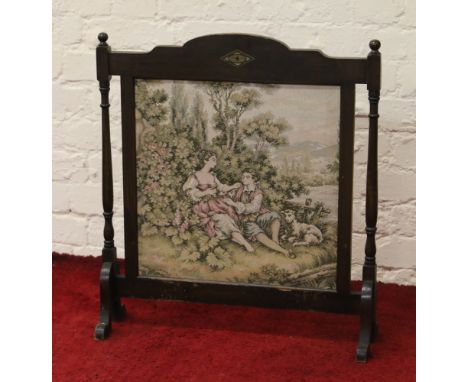A mahogany firescreen with tapestry panel.