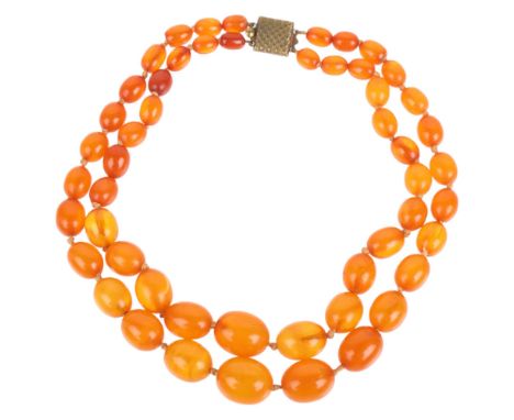 A Vintage double-strand graduated amber bead necklace, beads ranging from 18.6-9.7mm, 32cm, 45.8g . Condition Report: General