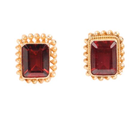 A pair of 9ct gold pink tourmaline stud earrings, each rub-over set with octagonal step-cut tourmaline within rope twist surr