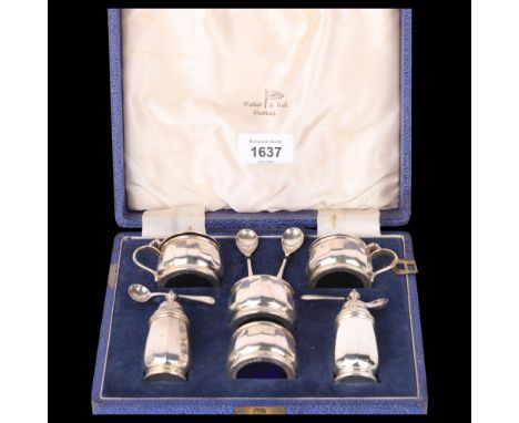 A cased Elizabeth II silver 6-piece cruet set, Walker & Hall, Birmingham 1956, cylindrical faceted form with blue glass liner