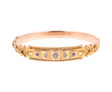 An Antique 9ct rose gold sapphire and diamond hinged bangle, maker WC & Co, Birmingham 1910, star set with round-cut sapphire