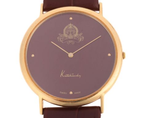 KUTCHINSKY - an 18ct gold 'Saudi Arabia Emblem' quartz wristwatch, maroon dial with gilt quarterly dot hour markers, pencil h