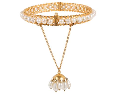 A Middle Eastern 18ct gold freshwater pearl hinged bangle, set throughout with 5mm pearls, rope twist edges suspending pearl 