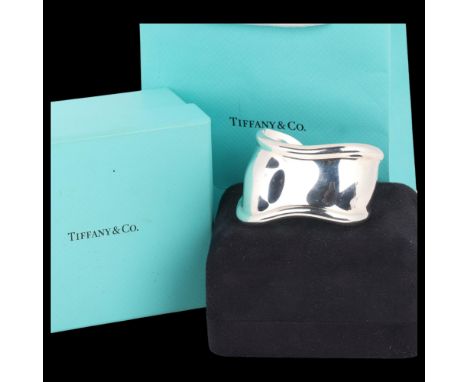 TIFFANY & CO - a sterling silver 'Bone' cuff bangle, designed by Elsa Peretti, signed, internal circumference 15cm, 51.7g, bo