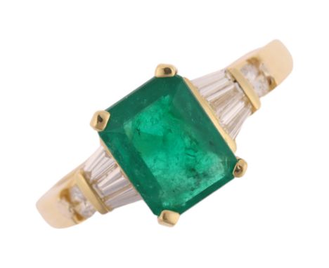 An 18ct gold emerald and diamond ring, claw set with 1.25ct octagonal step-cut emerald, flanked by tapered baguette and moder