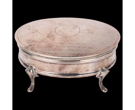 A George V silver dressing table jewel box, Lee & Wigfull, Sheffield 1927, oval form with engine turned lid raised on 4 feet,
