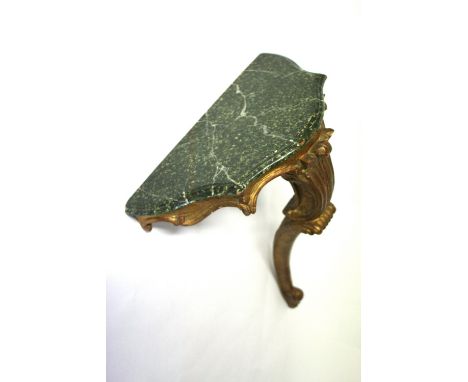 A Florentine giltwood wall bracket, second half 20th century, with painted faux marble top, 40cm wide.