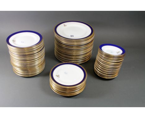 A matched Coalport Rutland and Carlton dinner Service, blue and gilt bordered with the crest of the Royal Army Pay Corps, twe
