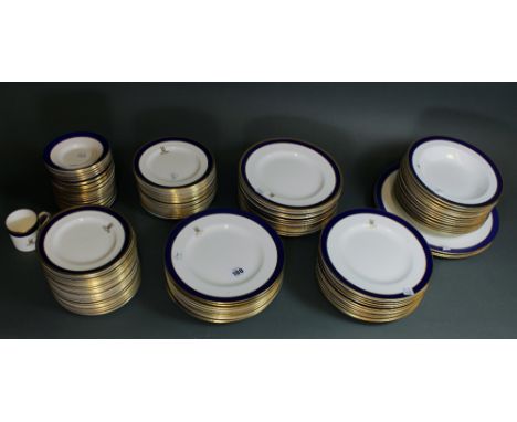 A matched Coalport Rutland and Carlton dinner Service, blue and gilt bordered with the crest of the Royal Army Pay Corps, thi