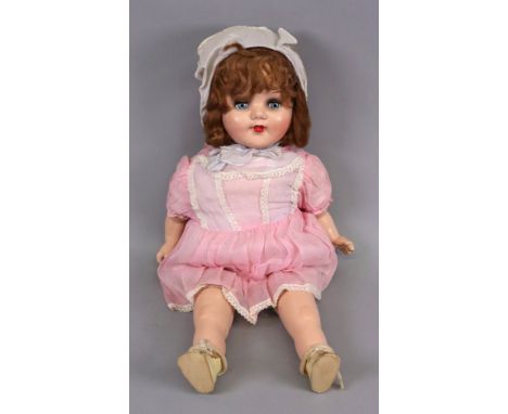 A vintage dressed doll, with sleeping eyes, composition head, hands and legs, 51cm high.