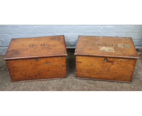 A pair of late Victorian oak chests, with sunk brass carrying handles, the hinged covers with studded initials 'D H' &amp; 'K